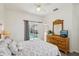 Comfortable bedroom featuring a ceiling fan, a chest of drawers and pool access at 475 Windsor Pl, Davenport, FL 33896