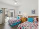 Comfortable bedroom with twin beds, wood furnishings, and sliding door access to the outdoors at 475 Windsor Pl, Davenport, FL 33896