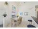 Bright dining room with a chandelier and large windows overlooking the pool area at 475 Windsor Pl, Davenport, FL 33896
