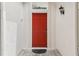 Inviting red front door with ornate hardware and a decorative transom window at 475 Windsor Pl, Davenport, FL 33896