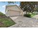 Charming home with a two-car garage and a brick paver driveway at 475 Windsor Pl, Davenport, FL 33896