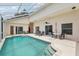 Inviting screened-in pool area with a spacious patio for entertaining at 475 Windsor Pl, Davenport, FL 33896
