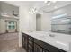 Elegant bathroom featuring a double sink vanity with dark cabinets, white countertop, and view into Primary bedroom at 2132 Antilles Club Dr, Kissimmee, FL 34747