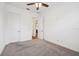An empty bedroom featuring neutral paint, plush carpeting and a ceiling fan fixture at 2132 Antilles Club Dr, Kissimmee, FL 34747
