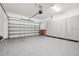 Spacious garage with epoxy flooring, built-in storage cabinets, and an insulated garage door at 2132 Antilles Club Dr, Kissimmee, FL 34747