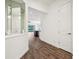Bright hallway with wood flooring, leading to an open-concept kitchen and living area at 2132 Antilles Club Dr, Kissimmee, FL 34747