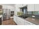 Modern kitchen featuring stainless steel appliances, white cabinets, and a gas stovetop at 2132 Antilles Club Dr, Kissimmee, FL 34747