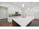 Modern kitchen with a large island, white cabinets, stainless steel appliances and modern pendant lights at 2132 Antilles Club Dr, Kissimmee, FL 34747
