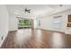 Bright living room with hardwood floors, sliding glass doors, and a tray ceiling with fan at 2132 Antilles Club Dr, Kissimmee, FL 34747
