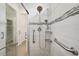 Walk-in shower with glass door, tiled walls, handrails, and multiple shower heads for a luxurious bathing experience at 2132 Antilles Club Dr, Kissimmee, FL 34747