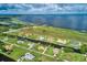A beautiful aerial view showcases waterfront homes along canals, with a large lake visible in the background at 3911 Gardenia Dr, Indian Lake Estates, FL 33855