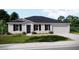 Charming single-story home featuring a well-manicured lawn and attached two-car garage at 3911 Gardenia Dr, Indian Lake Estates, FL 33855