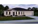 Charming single-story home featuring a well-manicured lawn and attached two-car garage at 3911 Gardenia Dr, Indian Lake Estates, FL 33855