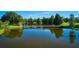 Picturesque view of a bridge over a serene lake, surrounded by lush greenery and clear blue skies at 3911 Gardenia Dr, Indian Lake Estates, FL 33855