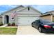 Two-story house with attached garage and landscaped front yard at 2657 Harmonia Hammock S Rd, Harmony, FL 34773