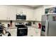 Modern kitchen with white cabinets and granite countertops at 2657 Harmonia Hammock S Rd, Harmony, FL 34773