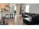 Living room features hardwood floors and L-shaped sectional sofa at 2657 Harmonia Hammock S Rd, Harmony, FL 34773