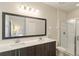 Double vanity bathroom with large mirror and shower at 233 Macaulay S Cv, Haines City, FL 33844