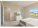 Bright bedroom featuring a comfortable bed and large window at 233 Macaulay S Cv, Haines City, FL 33844
