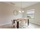 Bright dining room with glass table and seating for six at 233 Macaulay S Cv, Haines City, FL 33844