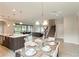 Kitchen and dining area with glass table and view of living room at 233 Macaulay S Cv, Haines City, FL 33844