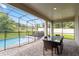 Screened pool and patio with table and chairs at 233 Macaulay S Cv, Haines City, FL 33844