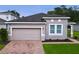 One-story home with attached garage and landscaped lawn at 3225 Stratton Cir, Kissimmee, FL 34744