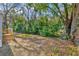 Private backyard space features mature trees and a small wooden deck at 9100 Sw 32Nd Ct, Ocala, FL 34476