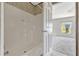 Bathroom with a tub/shower, tile flooring and a door leading to a bedroom at 9100 Sw 32Nd Ct, Ocala, FL 34476