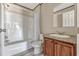 Clean bathroom with a tub/shower combination and a vanity with wooden cabinets at 9100 Sw 32Nd Ct, Ocala, FL 34476