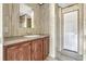 Bathroom featuring a wooden vanity, a sink, a mirror, and a door with a paneled wall at 9100 Sw 32Nd Ct, Ocala, FL 34476