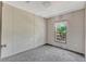 Cozy bedroom with neutral tones and a window offering natural light at 9100 Sw 32Nd Ct, Ocala, FL 34476