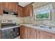 Kitchen with stainless steel appliances, wood cabinets, and a large sink at 9100 Sw 32Nd Ct, Ocala, FL 34476