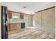 Efficient kitchen with black appliances, wood-look flooring, and plentiful counterspace at 9100 Sw 32Nd Ct, Ocala, FL 34476