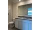 Bathroom with double vanity, granite countertops, and a large mirror at 670 Moscato Dr, Holly Hill, FL 32117