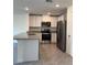 Modern kitchen featuring white cabinets, granite countertops, and stainless steel appliances at 670 Moscato Dr, Holly Hill, FL 32117