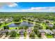 Stunning aerial of a community with mature trees and a pond providing natural beauty at 3872 Heirloom Rose Pl, Oviedo, FL 32766