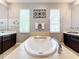 Luxurious bathroom features a soaking tub, double vanities, and tasteful decor at 3872 Heirloom Rose Pl, Oviedo, FL 32766