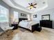 The main bedroom has neutral colored walls and tile floors with a ceiling fan and two windows at 3872 Heirloom Rose Pl, Oviedo, FL 32766