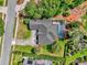Aerial view of property featuring pool, mature trees, and lush landscaping at 404 Hightower Dr, Debary, FL 32713