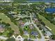 Neighborhood aerial showing a property with mature trees, manicured lawns, and nearby community amenities at 404 Hightower Dr, Debary, FL 32713