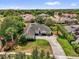Elevated shot showing home with palm tree, circular driveway, manicured lawn, and lush landscaping at 404 Hightower Dr, Debary, FL 32713