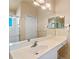 Large bathroom featuring tile floors, long vanity, dual sinks, and glass-enclosed shower at 404 Hightower Dr, Debary, FL 32713