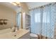 Well-lit bathroom featuring a vanity, mirror, and a shower with a patterned curtain at 404 Hightower Dr, Debary, FL 32713