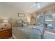 Comfortable bedroom featuring neutral walls, ceiling fan, and window with a view at 404 Hightower Dr, Debary, FL 32713