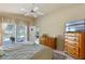 Bedroom featuring neutral walls, ceiling fan, dresser, and access to lanai at 404 Hightower Dr, Debary, FL 32713