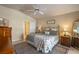 Cozy bedroom with neutral walls, ceiling fan, and view to hall at 404 Hightower Dr, Debary, FL 32713