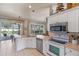 Clean kitchen features stainless steel appliances, white cabinetry, and seamless access to outdoor patio at 404 Hightower Dr, Debary, FL 32713