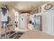 Bright kitchen features stainless steel refrigerator, white cabinets, and access to additional spaces at 404 Hightower Dr, Debary, FL 32713