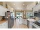 Modern kitchen with stainless steel appliances, white cabinets, and a view to the backyard at 404 Hightower Dr, Debary, FL 32713